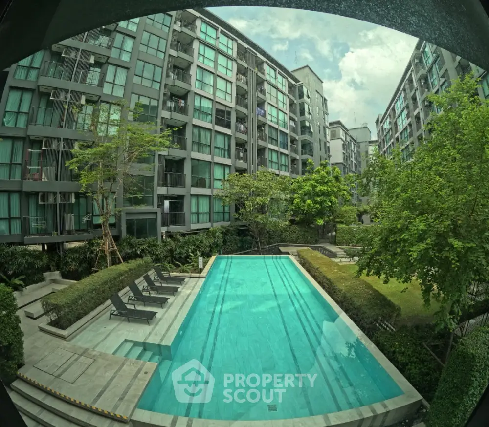 Modern condominium with lush garden and inviting swimming pool view