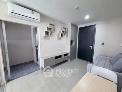 Modern living room with sleek design and air conditioning in a contemporary apartment.