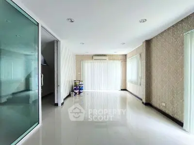 Spacious empty living room with modern design and large windows