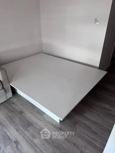 Modern minimalist interior with sleek platform bed and stylish flooring