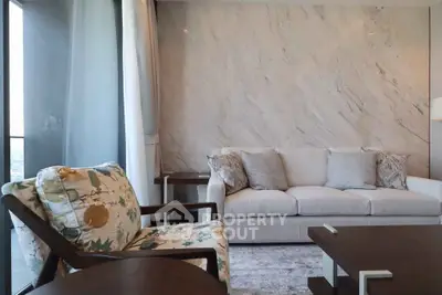 Elegant living room with modern decor and large windows offering natural light.