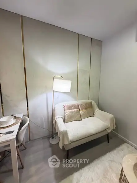 Cozy living room with modern decor and soft lighting, featuring a comfortable sofa and elegant dining area.
