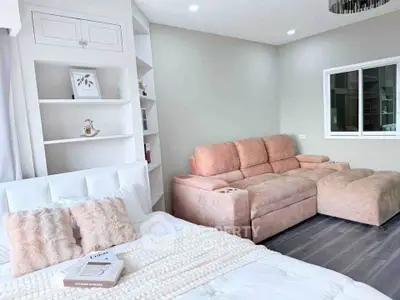 Modern bedroom with cozy pink sofa and elegant decor