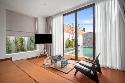 Modern living room with pool view, featuring sleek furniture and floor-to-ceiling windows.