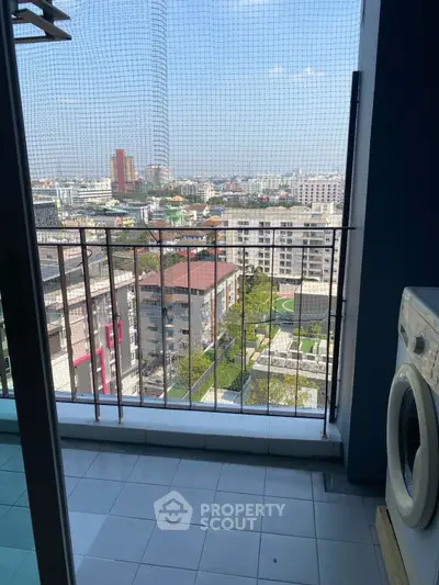 High-rise balcony with city view and washing machine, perfect for urban living.