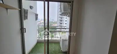 Modern apartment balcony with city view and glass sliding doors