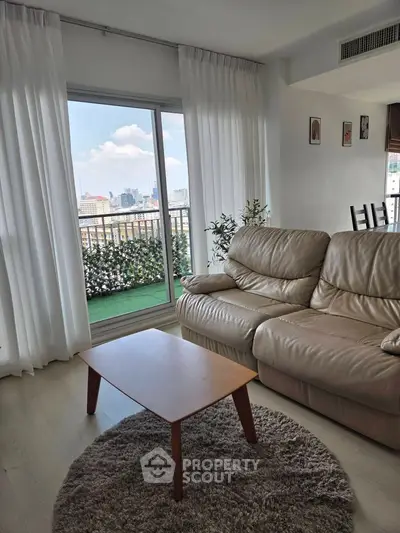Modern living room with leather sofa and city view balcony