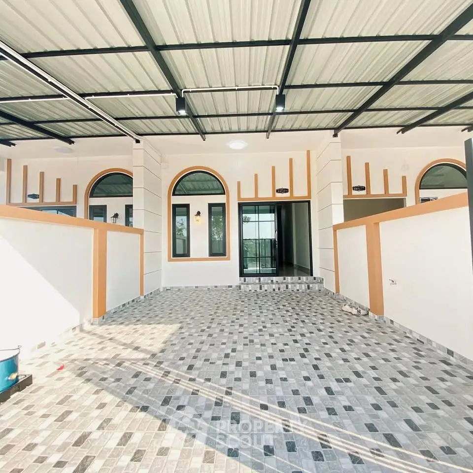 Modern house exterior with tiled driveway and arched windows