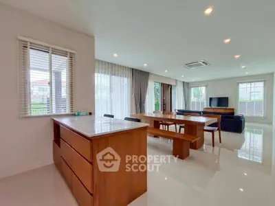 Spacious modern living room with open layout and elegant wooden furniture, perfect for family gatherings.