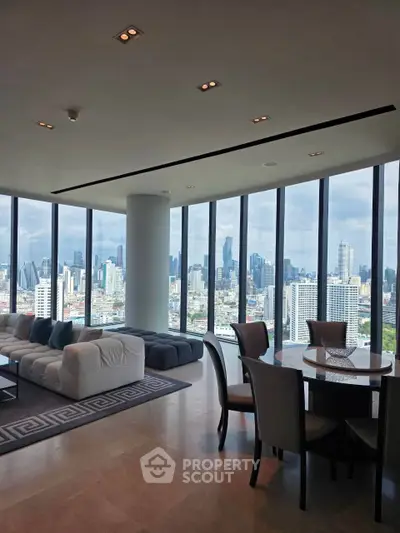Luxurious living room with panoramic city views and modern furnishings in a high-rise apartment.