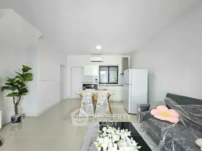 Modern living room with sleek kitchen, stylish furniture, and bright open layout in contemporary apartment.