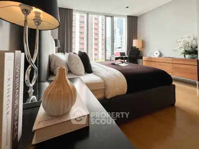 Luxurious bedroom with modern decor and city view, featuring elegant furniture and stylish design.