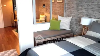 Modern bedroom with stylish decor and cozy seating area, perfect for relaxation.