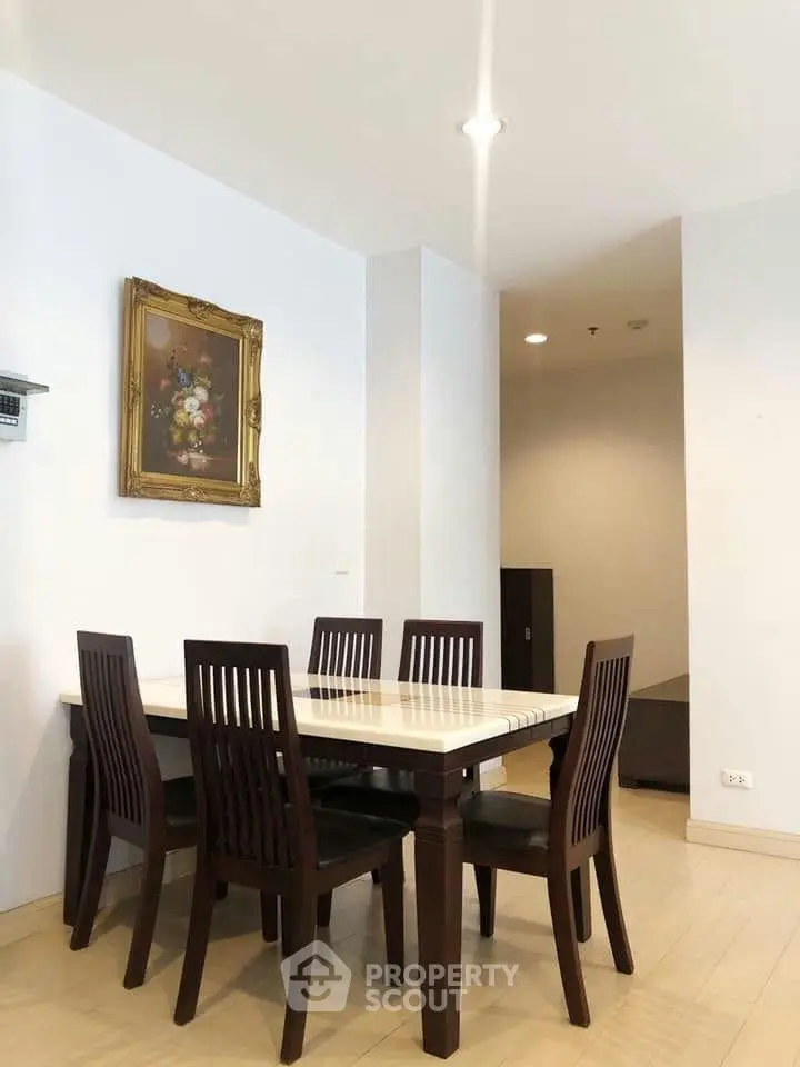 Elegant dining area with wooden table and chairs, perfect for family gatherings in a cozy home setting.