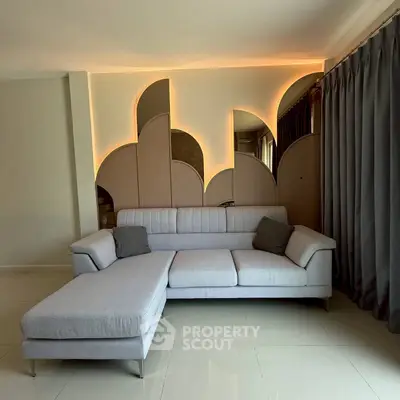 Modern living room with stylish sectional sofa and unique wall design
