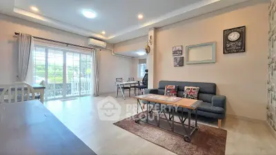 Spacious living room with stylish decor and large windows for natural light.
