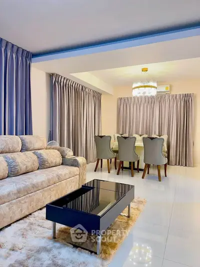 Luxurious living room with plush sofa, elegant dining set, and chic chandelier in modern apartment.