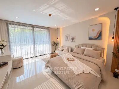 Luxurious bedroom with elegant decor and large windows offering natural light.
