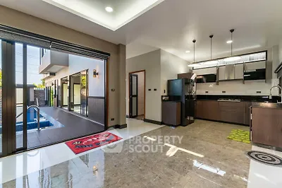 Modern open-layout kitchen with pool view and sleek design