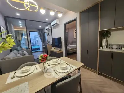 Modern open-plan living and dining area with stylish decor and city view balcony.