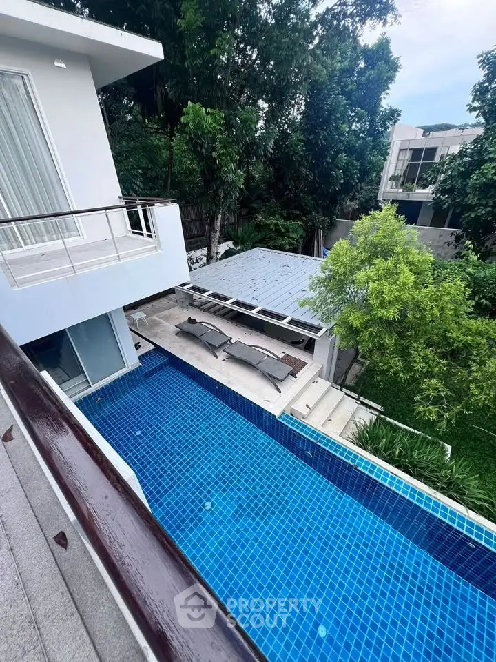 Luxurious modern home with private pool and lush greenery