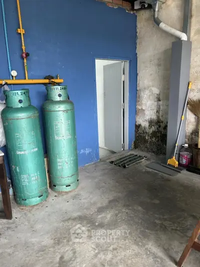 Industrial storage area with gas cylinders and utility door