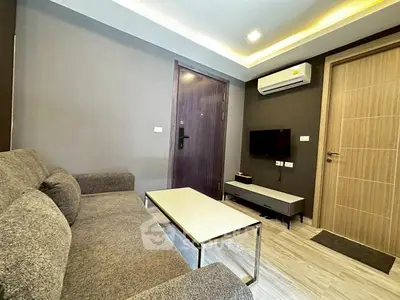 Modern living room with sleek furniture and air conditioning unit