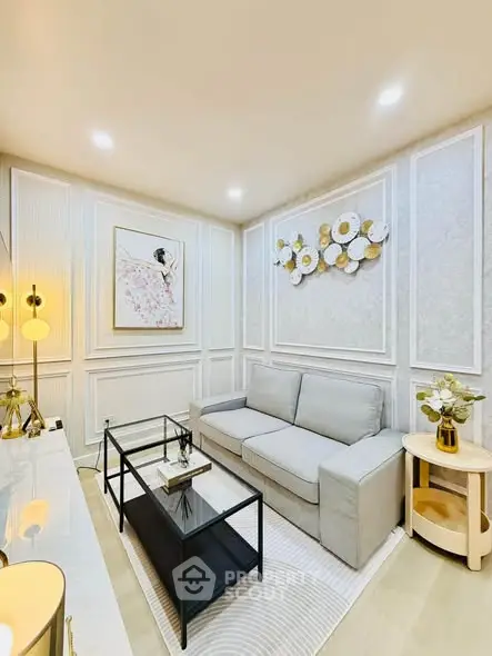 Elegant living room with modern decor, featuring a cozy sofa, stylish wall art, and ambient lighting.
