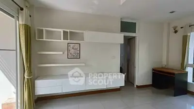 Spacious modern living room with sleek white cabinetry and natural light