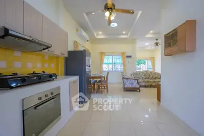 Spacious open-layout kitchen and living room with modern appliances and elegant decor.