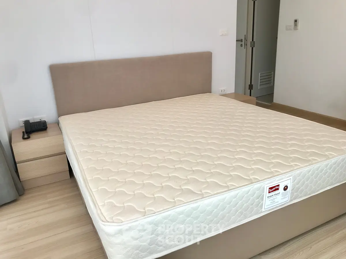 Spacious bedroom with modern design featuring a comfortable bed and stylish decor.