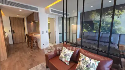 Modern studio apartment with stylish glass partition and cozy living area