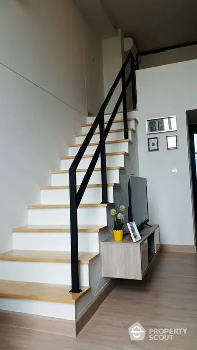 Modern interior with stylish staircase and TV unit in a contemporary home