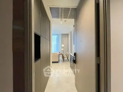 Stylish modern apartment entrance leading to a cozy living room with elegant decor.