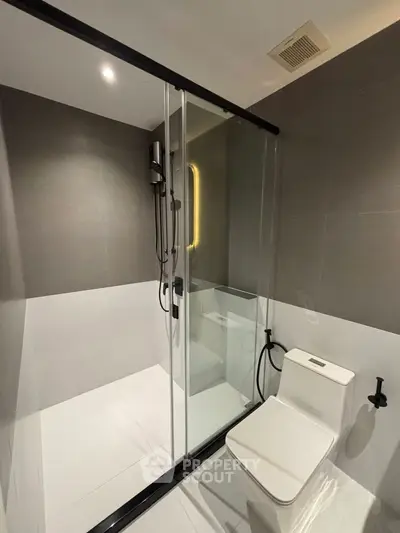 Modern bathroom with sleek shower and contemporary toilet design.