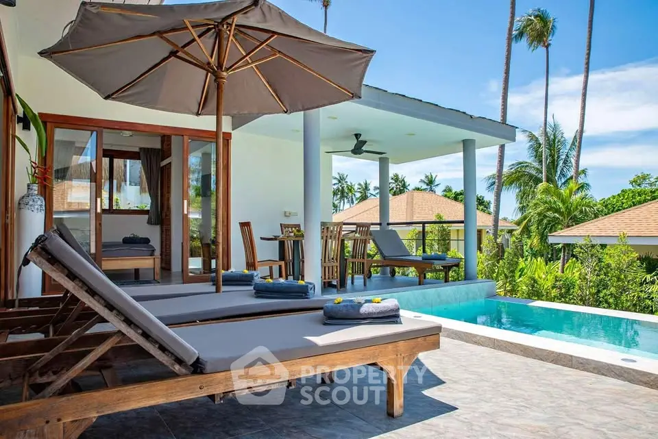 Luxurious tropical villa with private pool and sun loungers, perfect for relaxation.