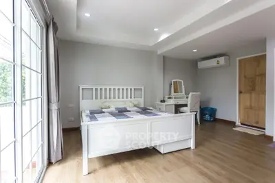 Bright and spacious bedroom with modern decor and large windows