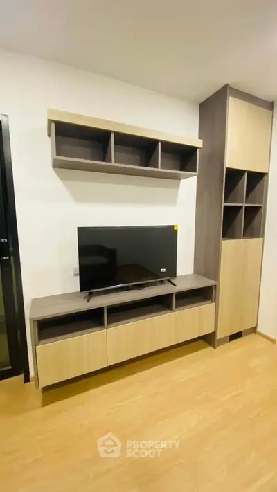 Modern living room with sleek TV stand and shelving unit, perfect for stylish home entertainment setup.