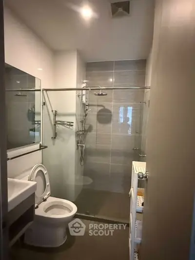 Modern bathroom with glass shower enclosure and sleek fixtures
