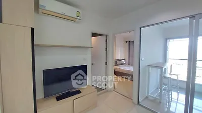Modern apartment interior with TV, air conditioning, and bedroom view