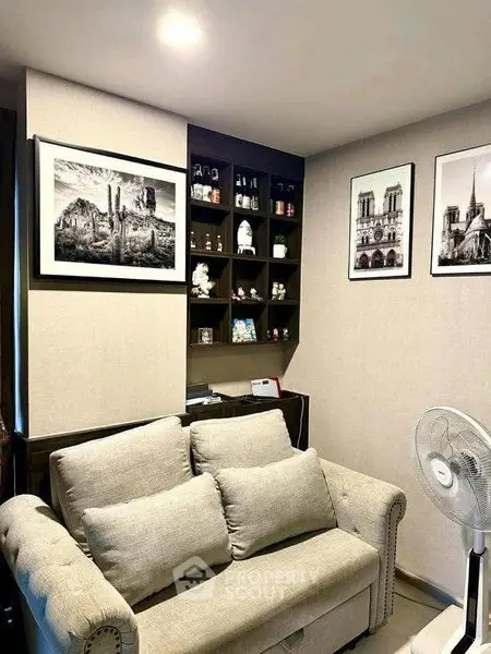 Cozy living room with elegant sofa and artistic wall decor, perfect for relaxation and style.