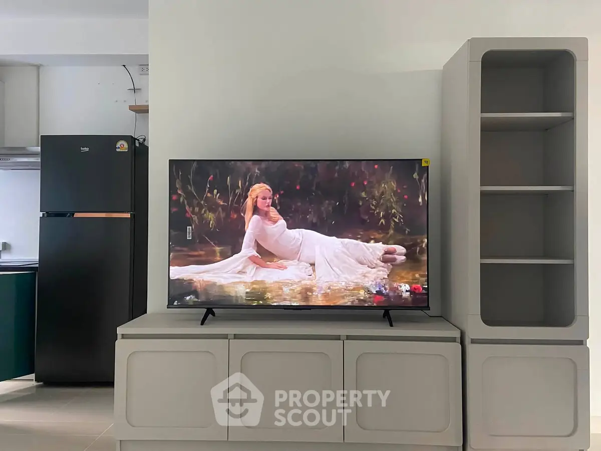 Modern living room with sleek TV setup and stylish shelving unit, perfect for contemporary living.