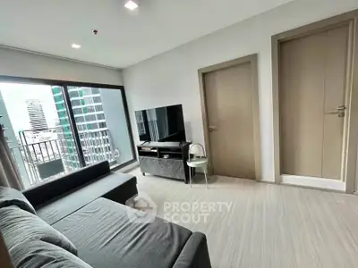 Modern living room with city view, sleek furniture, and large windows in a high-rise apartment.