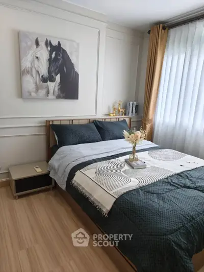 Elegant bedroom with stylish decor and natural light, featuring a cozy bed and horse artwork.