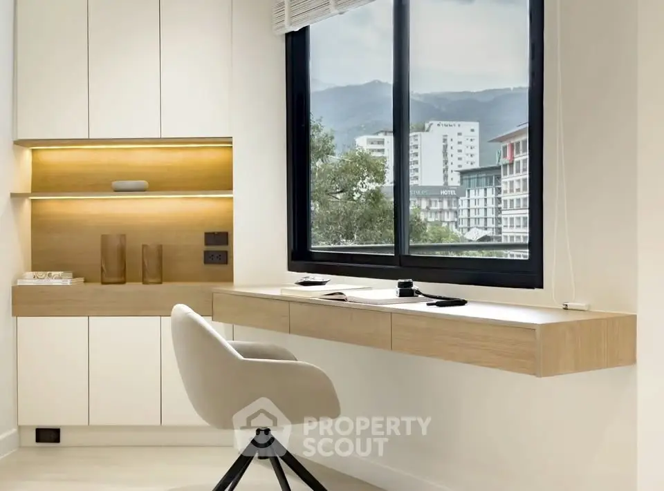 Modern study room with sleek desk and scenic window view in urban apartment