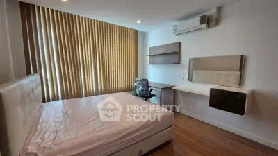 Modern bedroom with wooden flooring, large window, and air conditioning unit.