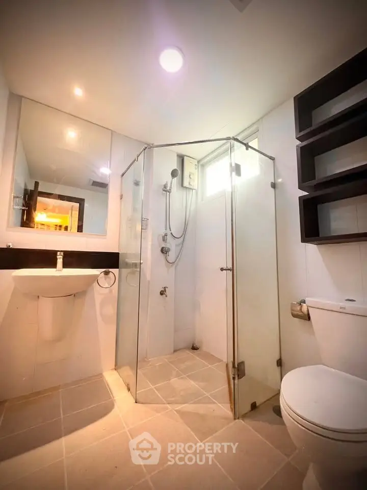 Modern bathroom with glass shower enclosure and sleek fixtures