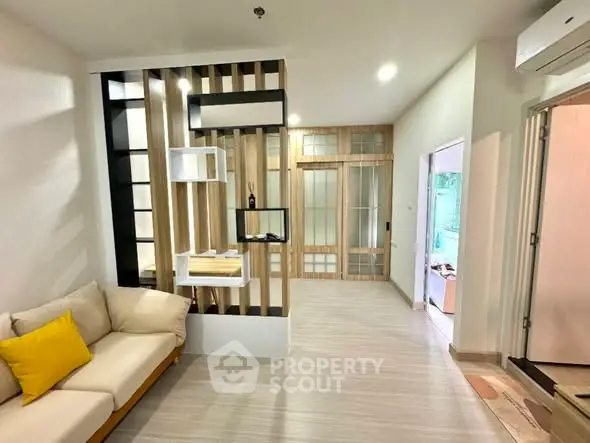 Modern living room with stylish partition and cozy sofa in contemporary apartment.