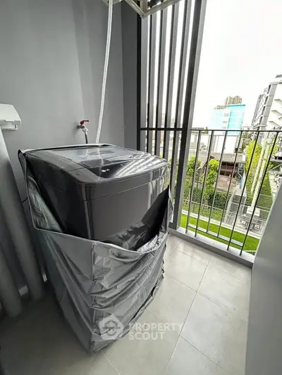 Modern balcony with washing machine and city view, perfect for urban living convenience.