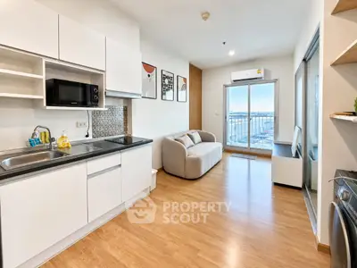 Modern open-layout kitchen and living room with balcony view in a stylish apartment.